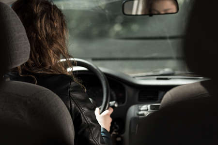 Photo of female car driver traveling by vehicleの写真素材