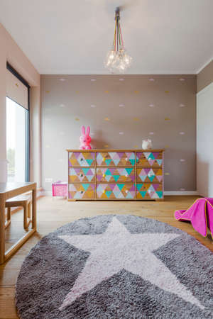 Beautiful baby girl room with a decorative star carpetの写真素材