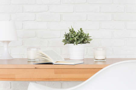 Light interior with a wooden table, white chair and decorative brick wallの写真素材