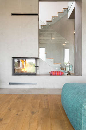 Industrial design livign room with a fireplace and hardwood flooringの写真素材