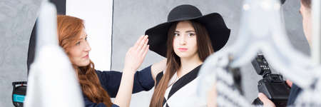 Stage manger, photographer and young model during session for fashion magazineの写真素材