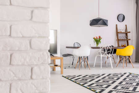 Shot of a brick wall, a TV and a table in a modern studioの写真素材