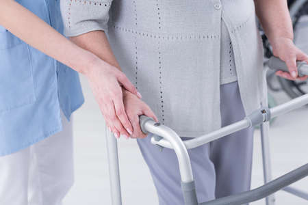 Cropped picture of a doctor assisting her senior patient who's using a walker for supportの写真素材