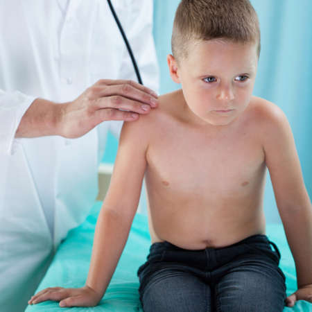 Pediatrist makes chest auscultation to little boyの写真素材