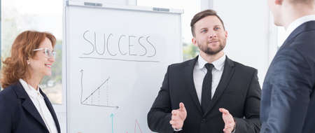 Shot of a young businessman presenting his ideas to his partnersの写真素材