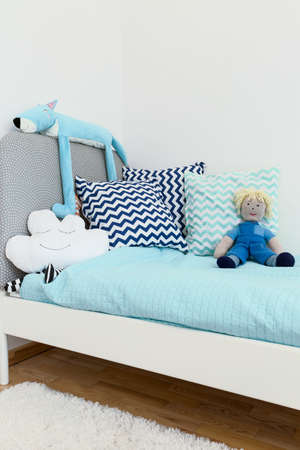 Shot of a bed in a cosy blue children's room