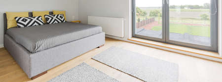 Panoramic picture of a king-size bed in a spacious bedroomの写真素材