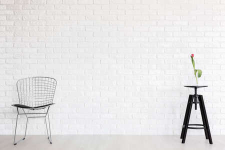 Shot of a room with a gap chair and a table with a tulipの写真素材