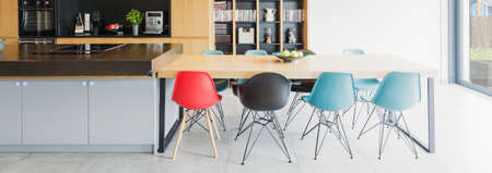 Panoramic picture of a modern kitchen with a big tableの写真素材