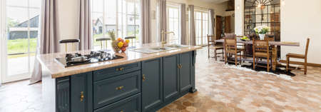 Stylish kitchen open to an elegant dining areaの写真素材