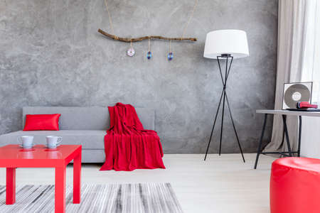 Shot of a beautiful living room with a red coffee tableの写真素材