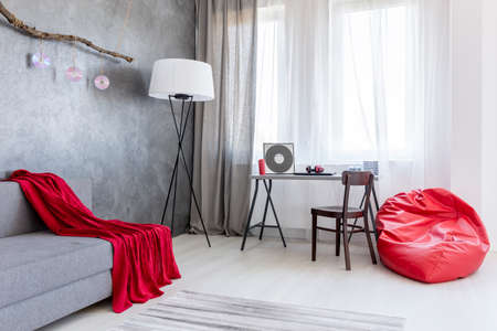 Shot of a spacious living room interior designed in gray tones