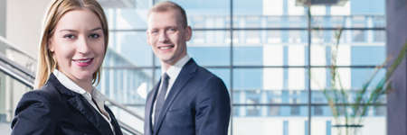Happy young businesspeople in office after successful business meeting