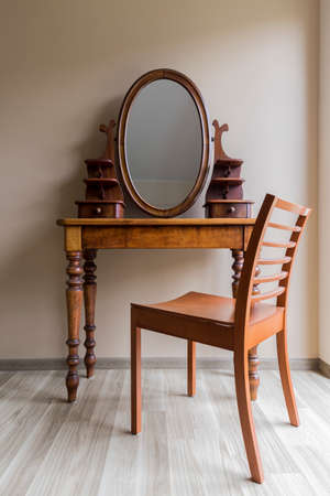 Shot of a wooden antique dressing table with an oval mirrorの写真素材