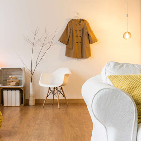 Room with flooring and modern furniture Comfortable sofa, chair and yellow pouffeの写真素材