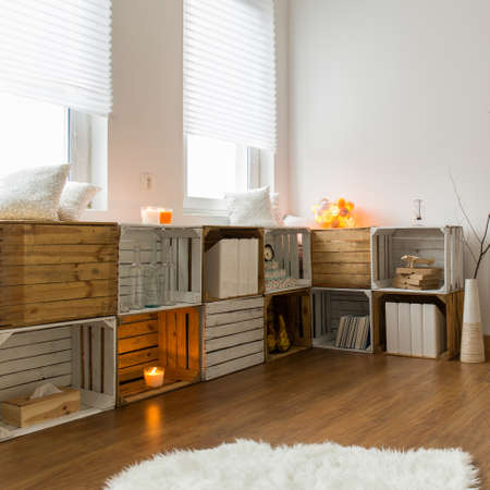 Room with ecological, handmade wooden bookcase and table. Warm interior with flooringの写真素材