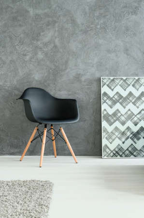 Part of room with modern chair and interesting geometrical paintingの写真素材