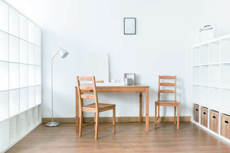 Bright and calm interior in modern house with table and storage spaceの写真素材