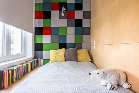 Cropped shot of a small bedroom interior with colorful decoration on the wallの写真素材