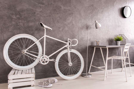 Classy white bike storing in female minimalist roomの写真素材