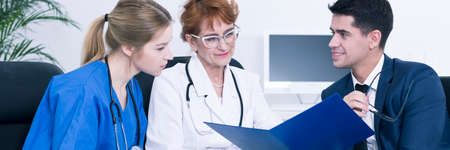 Doctors and nurse talking in office meeting
