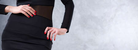 Close shot of an attractive woman in simple black dress, panoramaの写真素材