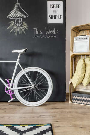 New design interior with blackboard wall, DIY storage and bike