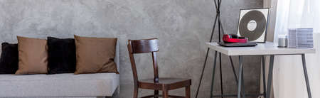 Shot of a grey living room with a sofa and a tableの写真素材