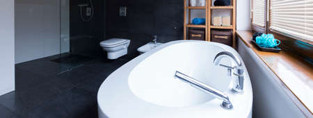 Shot of a big white bath in a modern bathroomの写真素材