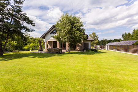 Exterior view of a new style house with large lawnの写真素材