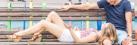 City lifestyle- young couple relaxing on city bench