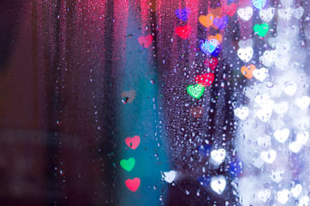 Raindrops and colorful bokeh hearts- lights rain bokehの写真素材