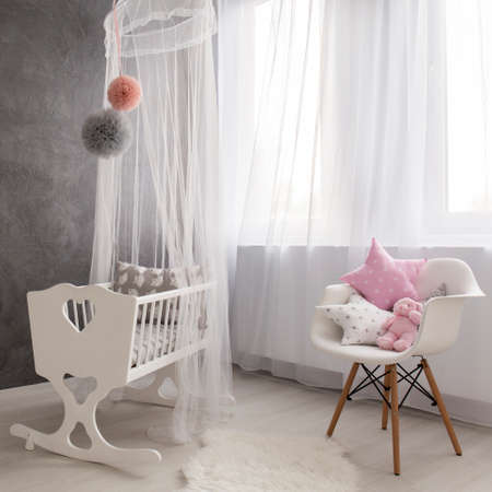 Shot of a cozy baby girl room with a big windowの写真素材