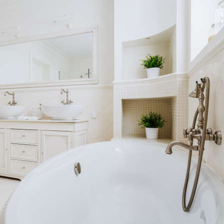 Close up of bathtub with elegant antique tap