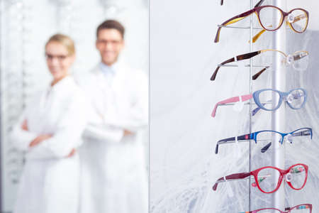 Glasses display at optician store and opticians in the backgroundの写真素材