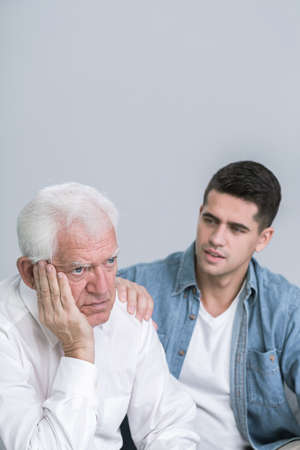Shot of a young man apologising to his very sad father