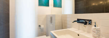 Bathroom interior with toilet, sink and bright backlight