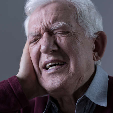 Elder man having pain in the ear