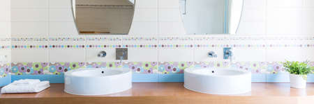 Cropped shot of a bathroom interior with two sinks and two mirrorsの写真素材