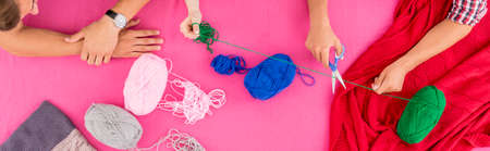 Group of friends making a present from knitting wool - view from aboveの写真素材