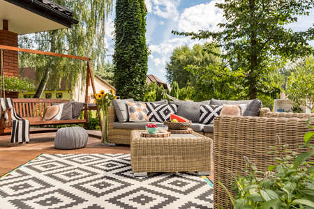 New design villa patio with comfortable rattan furniture and pattern carpet