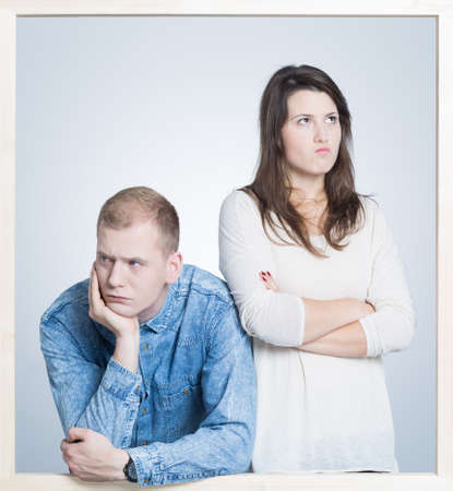 Picture in a frame of a young couple angry at each other
