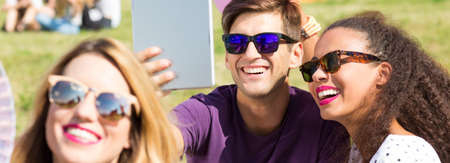 Smiled young couple posing to the common photo