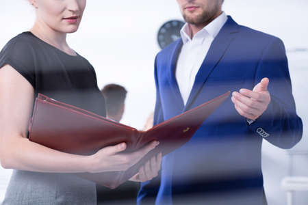 Close up of man and woman analyzing business documentsの写真素材