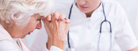 Shot of a young doctor talking to a concerned patientの写真素材