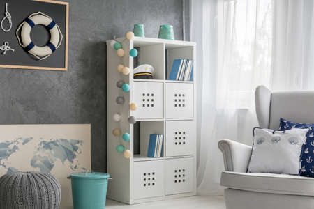 Corner of a living room with the white rack and comfortable armchairの写真素材