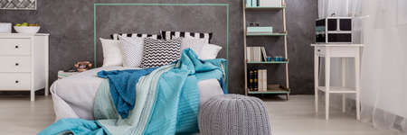 Cyan bedroom with the marital bed with pillows in the middle