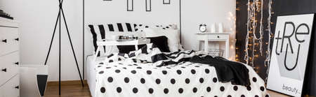 Panoramic shot of a double bed with dot and stripe sheetsの写真素材