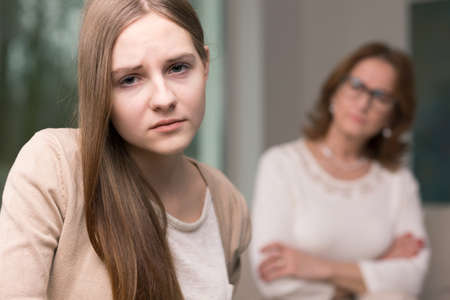 Closer shot of depressed young woman in therapy centerの写真素材