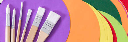 Close-up of various paint brushes on colorful backgroundの写真素材
